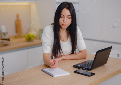 smiling young woman looking at laptop screen, reading good news in message, watching video, chatting in social network or shopping online at home, enjoying leisure time with computer © YURII Seleznov