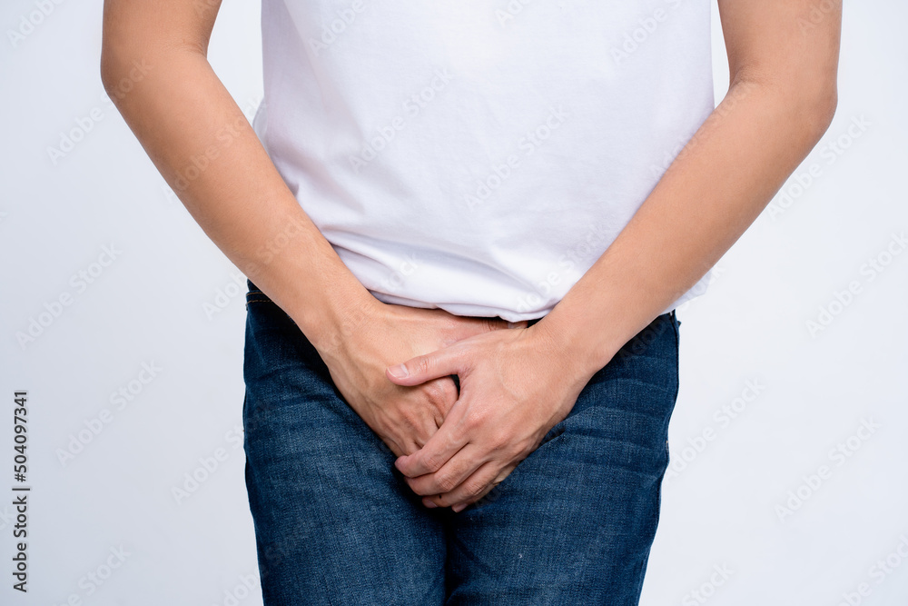Young man holding his crotch suffering from Diarrhea, incontinence, prostatitis, venereal disease. Healthcare concept.