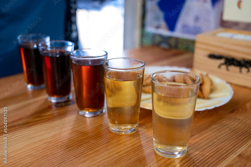 Tasting of different sweet wines from wooden barrels owith cheese n old bodega in central part of Malaga, Andalusia, Spain Tasting of different sweet wines from wooden barrels owith cheese n old bodega in central part of Malaga, Andalusia, Spain