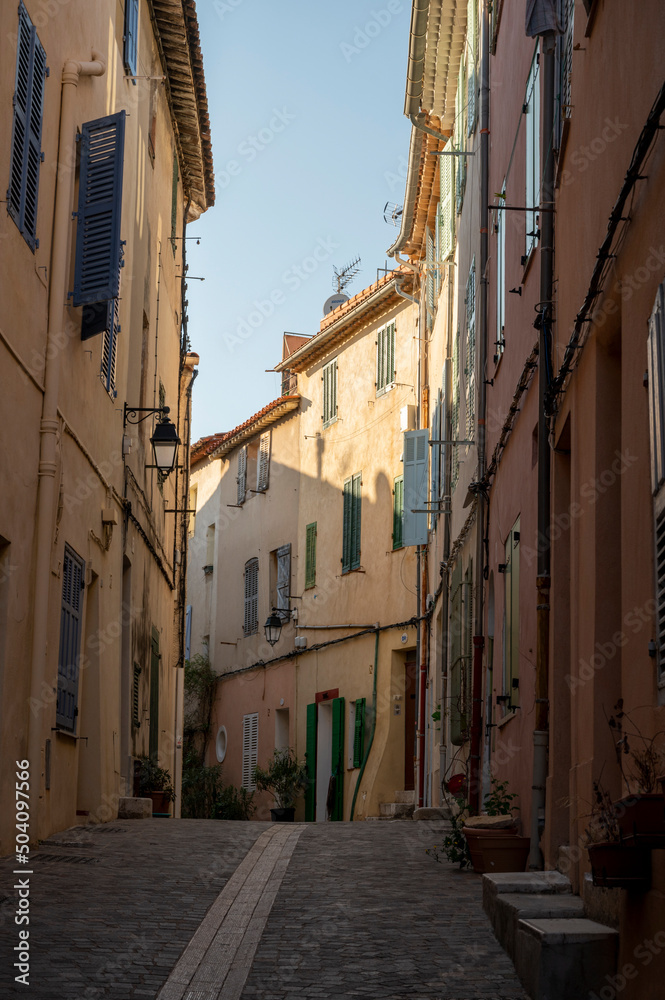 Sunny day in South of France, walking in ancient Provencal coastal town Cassis, narrow streets and colorful buildings, Provence, France