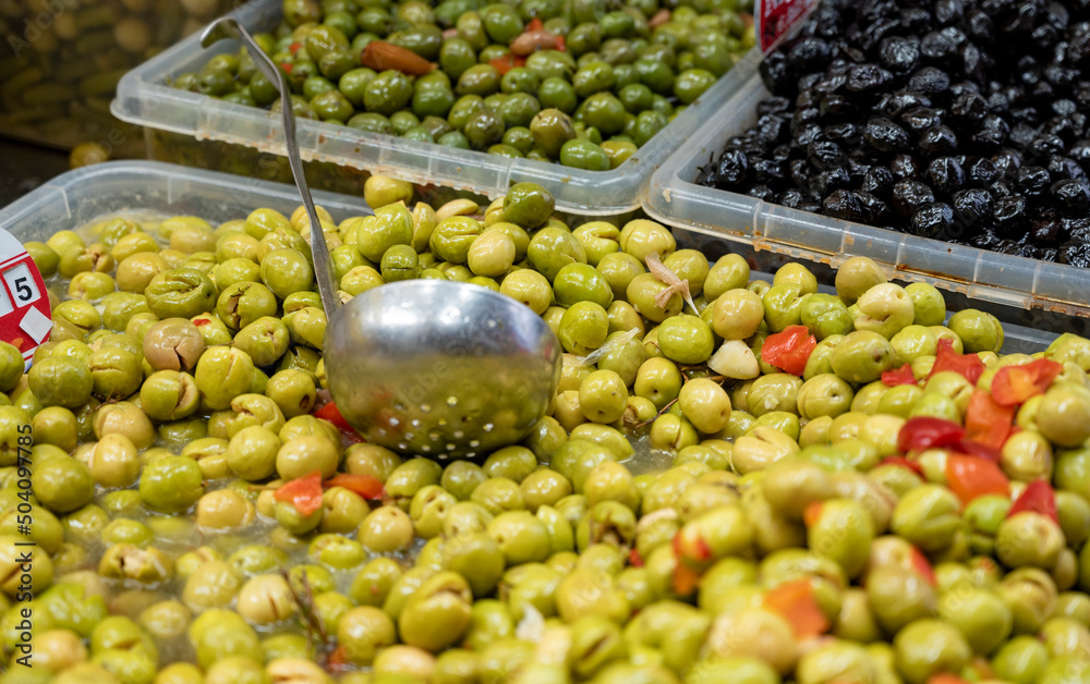 Assortment of pickled green olives on farmers market in Malaga, Andalusia, Spain