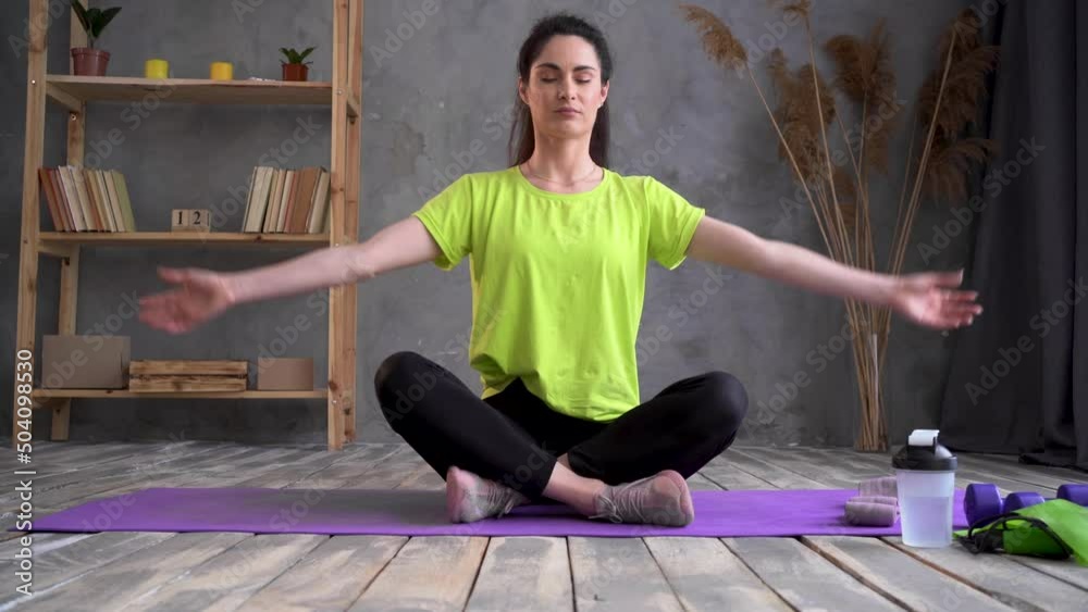 yoga at home, young latin woman in lotus position sitting on a sports ...
