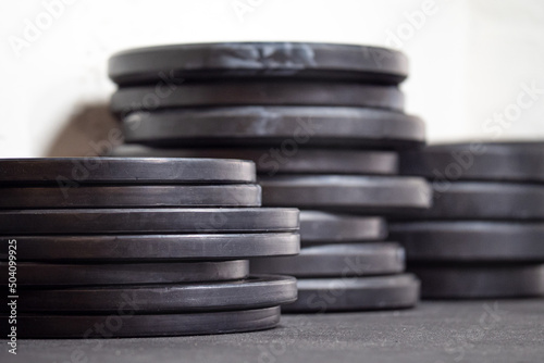 Image of black gym weigth plates on the floor