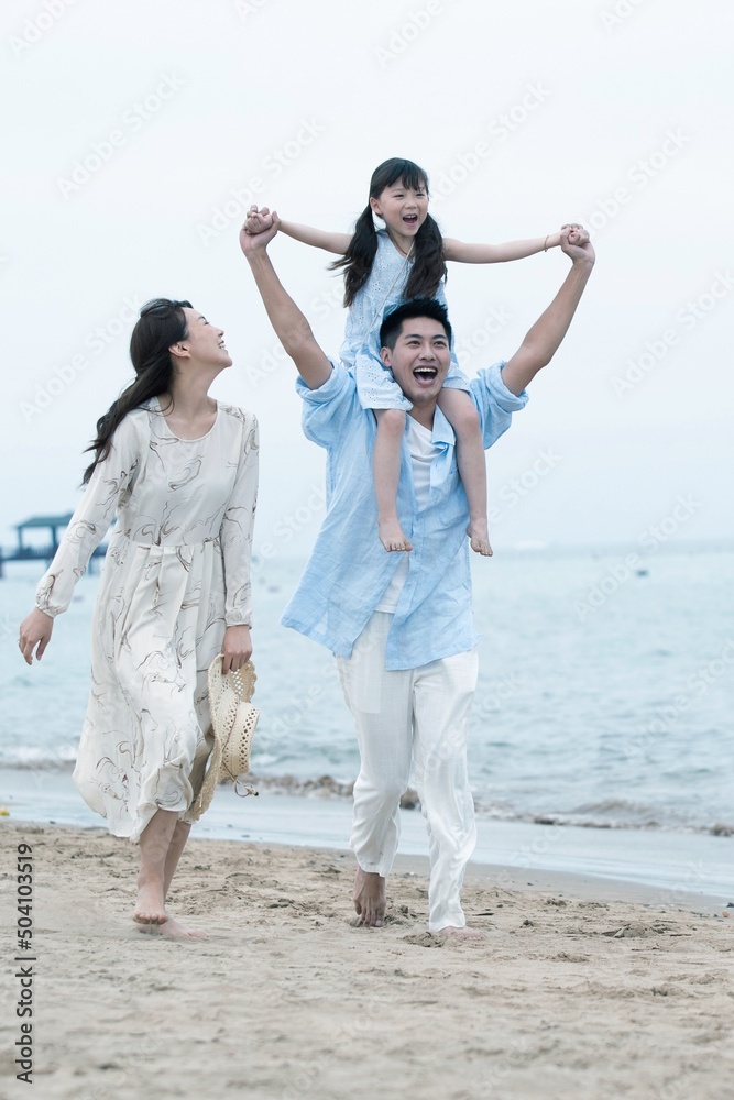 Family of three playing on the beach Family of three playing on the beach