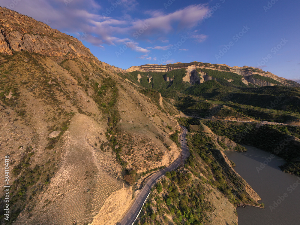 panoramic view of the Caucasus Mountains gorges and curved mountain roads on a spring day