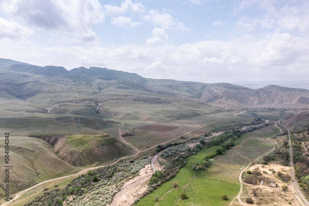 panoramic view of the Caucasus Mountains gorges and curved mountain roads on a spring day