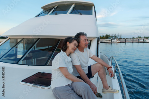 The elderly couple aboard a yacht out to sea photo