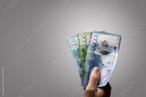 Kazakh Tenge banknotes held by a hand