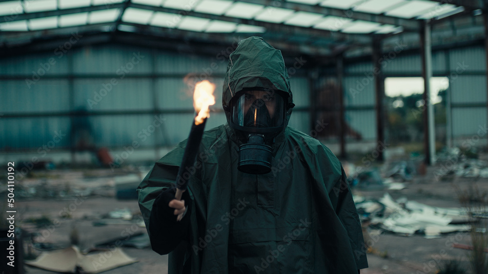 Soldier man with gas mask in a destroyed building by war with torch Soldier man with gas mask in a destroyed building by war with torch