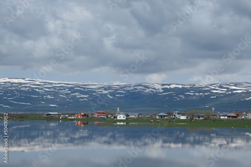 reflection of mountains and houses in water.Ardahan .Turkey photo