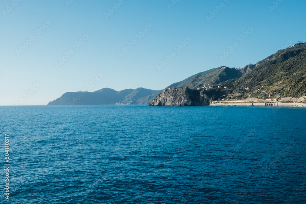 Beautiful seascape with blue sky, smooth water surface and rocky cliffs in Liguria coastal area. Popular italian travel destination. Beautiful seascape with blue sky, smooth water surface and rocky cliffs in Liguria coastal area. Popular italian travel destination.