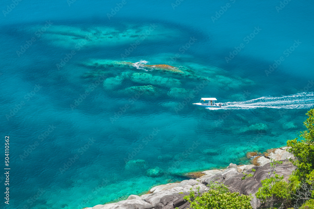 Seychelles - Mahe - White speed boat off the granite coast of Island Mahe near Anse Major beach