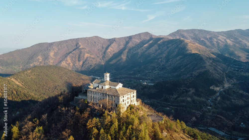 Fototapeta premium Aerial view of Sanctuary of Saint Ignatius of Loyola situated in the Lanzo Valleys in Italy. Tourist attraction and famous place of pilgrimage in Province of Turin, Piedmont region. Drone photography.