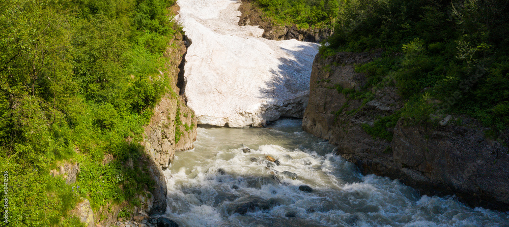 Spring streams of water and waterfalls on mountain streams in Dombay, mountainous territory, ski resort and nature reserve of the North Caucasus Spring streams of water and waterfalls on mountain streams in Dombay, mountainous territory, ski resort and nature reserve of the North Caucasus