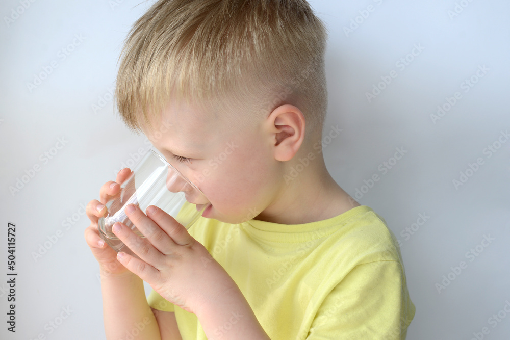 little boy drinks water from a glass little boy drinks water from a glass