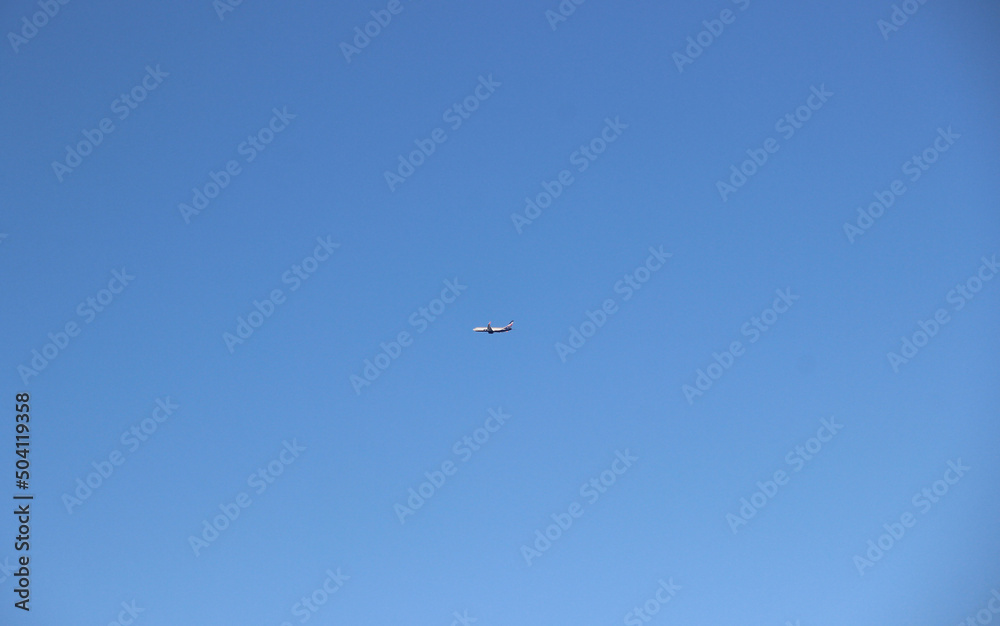Silhouette of a passenger plane against a clear sky