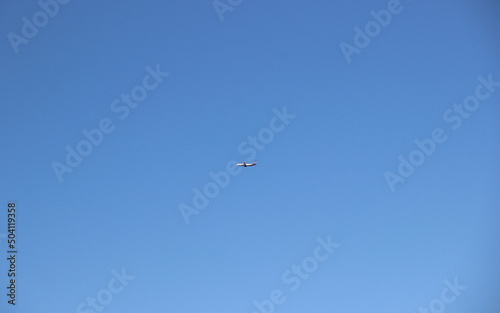 Silhouette of a passenger plane against a clear sky