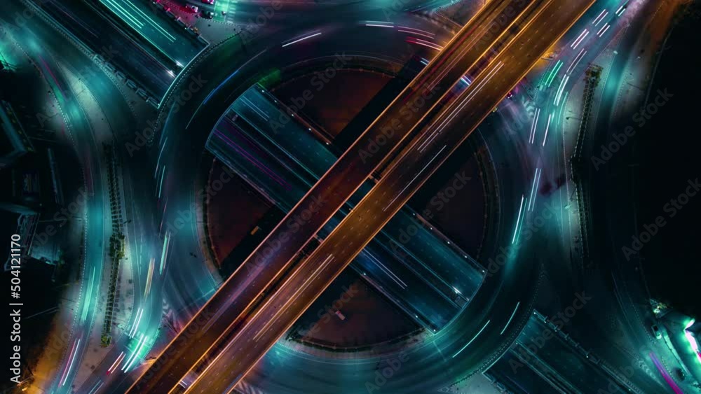 Hyperlapse time-lapse of car traffic transportation above circle roundabout road in Asian city. Drone aerial view fly in circle, high angle. Public transport or commuter city life concept	