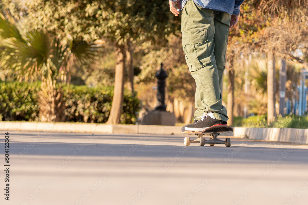 Man with his skateboard in the city medium flat plane