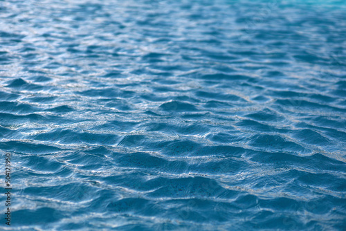 Blue pool water surface with waves. Water background.