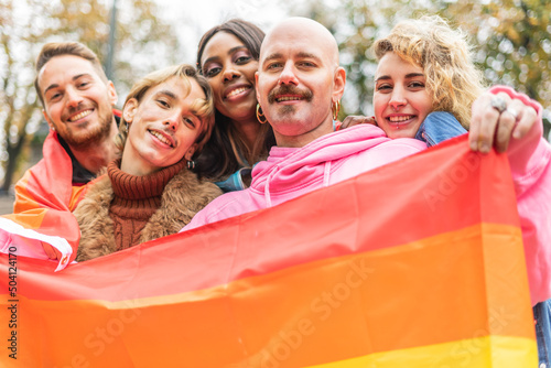 Portrait of activists manifesting for human and lgbt rights with rainbow flag