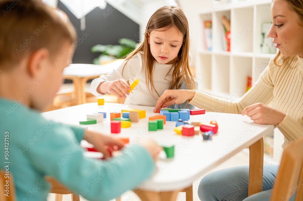 Kindergarten children playing with colorful building blocks. Healthy learning environment. Learning through play. Kindergarten children playing with colorful building blocks. Healthy learning environment. Learning through play.