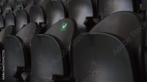 Empty plastic seats in a stadium. Matches to be played without fans.