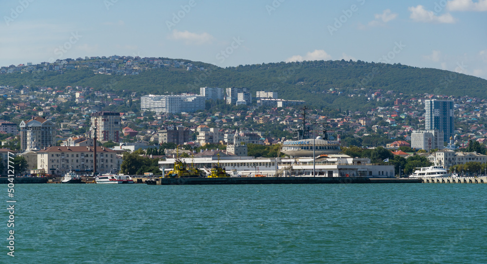 View of Novorossiysk Embankment of Admiral Serebryakov and the building of Marine Station from side of Western mole. Novorossiysk, Russia - September 15, 2021