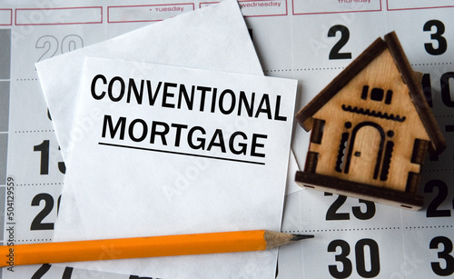 CONVENTIONAL MORTGAGE - word on white paper on the background of a house, pencil and calendar
