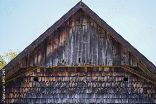 Fototapeta Naklejka Na Ścianę i Meble -  Wooden farmhouse in Bavaria with many details from the roof to wooden windows and doors