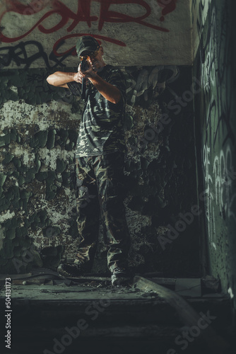Airsoft soldier in the old industry building.