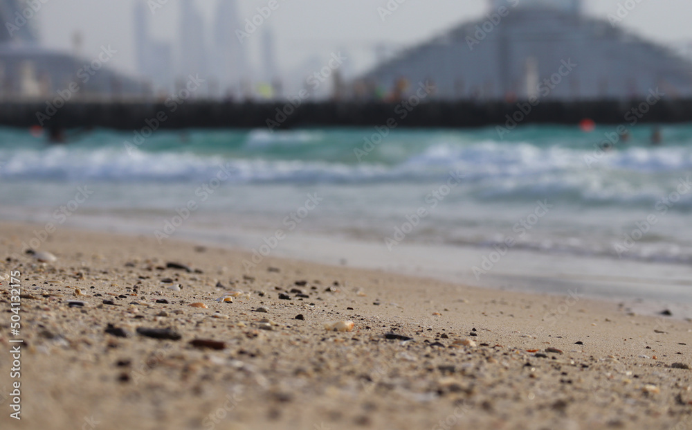 Close-up of a sandy beach in Dubai, partially out of focus