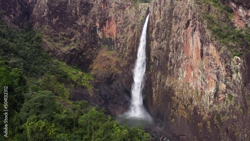 Beautiful Wallaman Falls waterfall aerial tracking backward with rainforest, Queensland photo