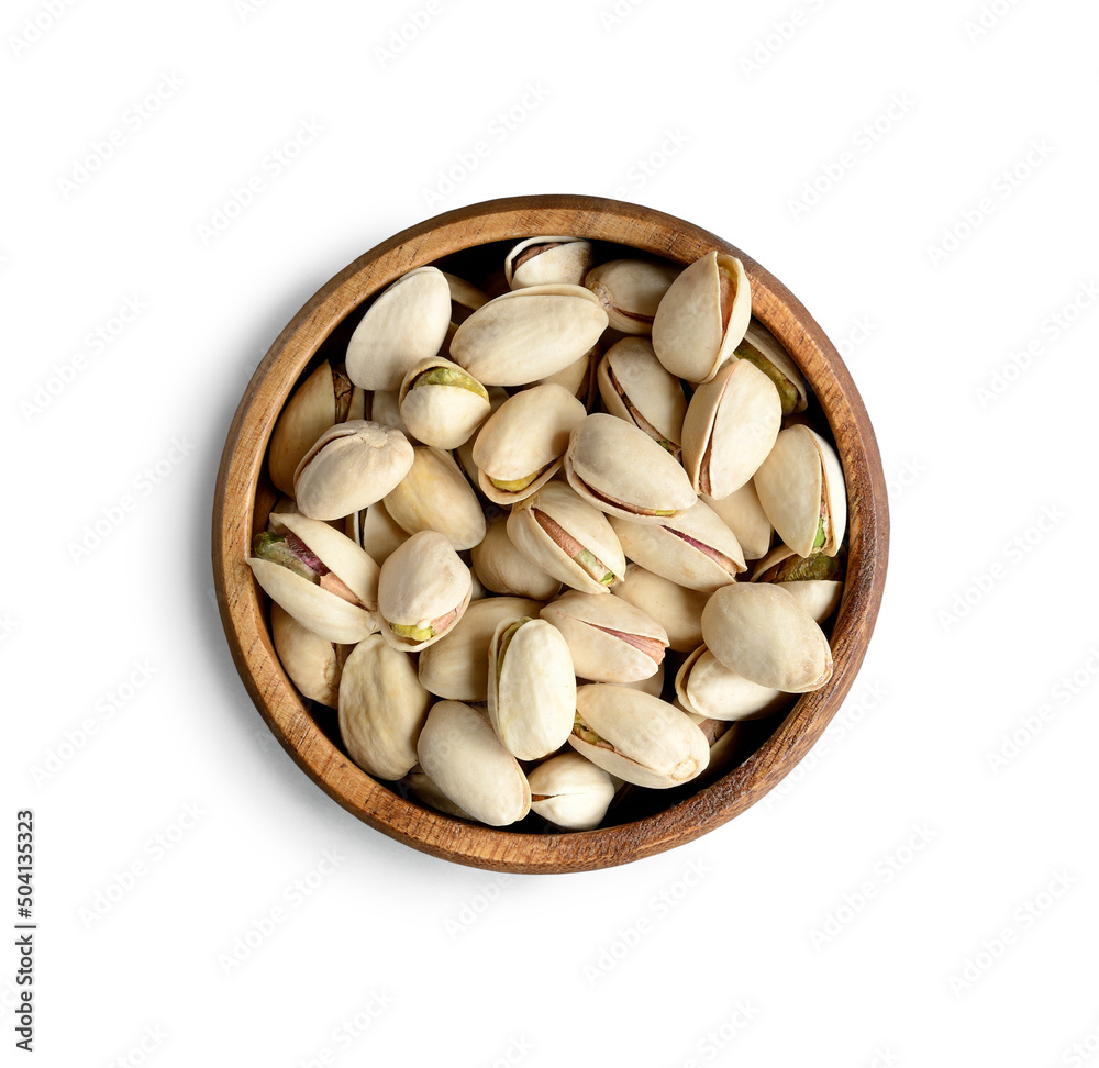 Pistachios in a wooden cup, close-up isolated on a white background. Pistachios in a wooden cup, close-up isolated on a white background.