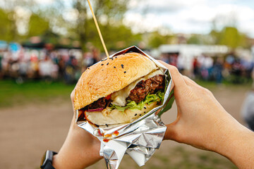 Eating burgers at an outdoor street food festival