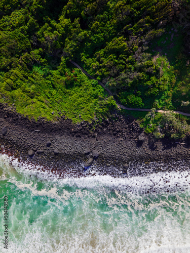 Aerial long exposure of rocky shoreline with walking track. Burleigh Heads, Queensland, Australia.