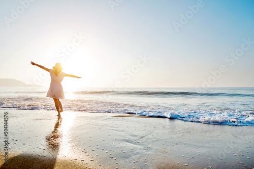 Young woman having fun walking on seaside. photo