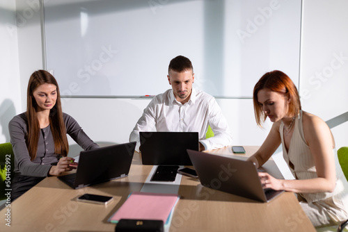 Colleagues in the meeting room communicate about a business project