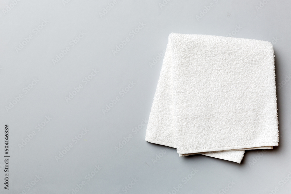 Fototapeta premium Top view of white towels with copy space on colored background
