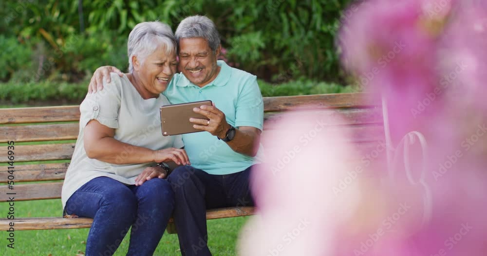 Video of happy biracial senior couple using tablet in garden Video of happy biracial senior couple using tablet in garden