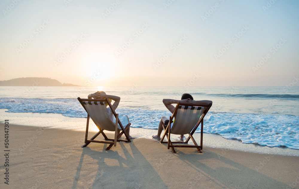 Couple sunbathing on a beach chair. Couple sunbathing on a beach chair.