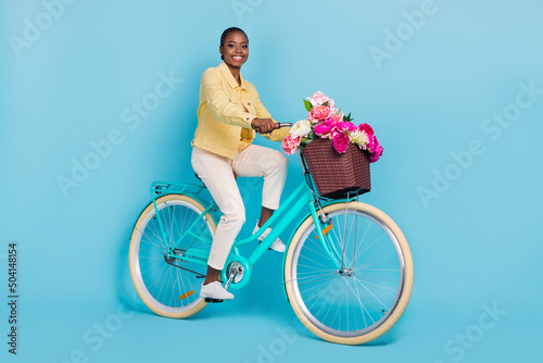 Full length body size view of attractive girl riding bike spending day free time isolated over bright blue color background