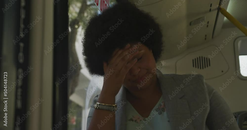 Thoughtful plus size biracial woman sitting in bus Thoughtful plus size biracial woman sitting in bus