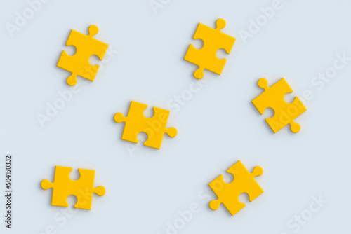 Yellow jigsaw puzzle pieces on white background. Flat lay. 3d render