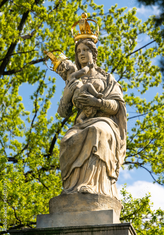 Statue of the Virgin Mary with baby Jesus in the spring garden