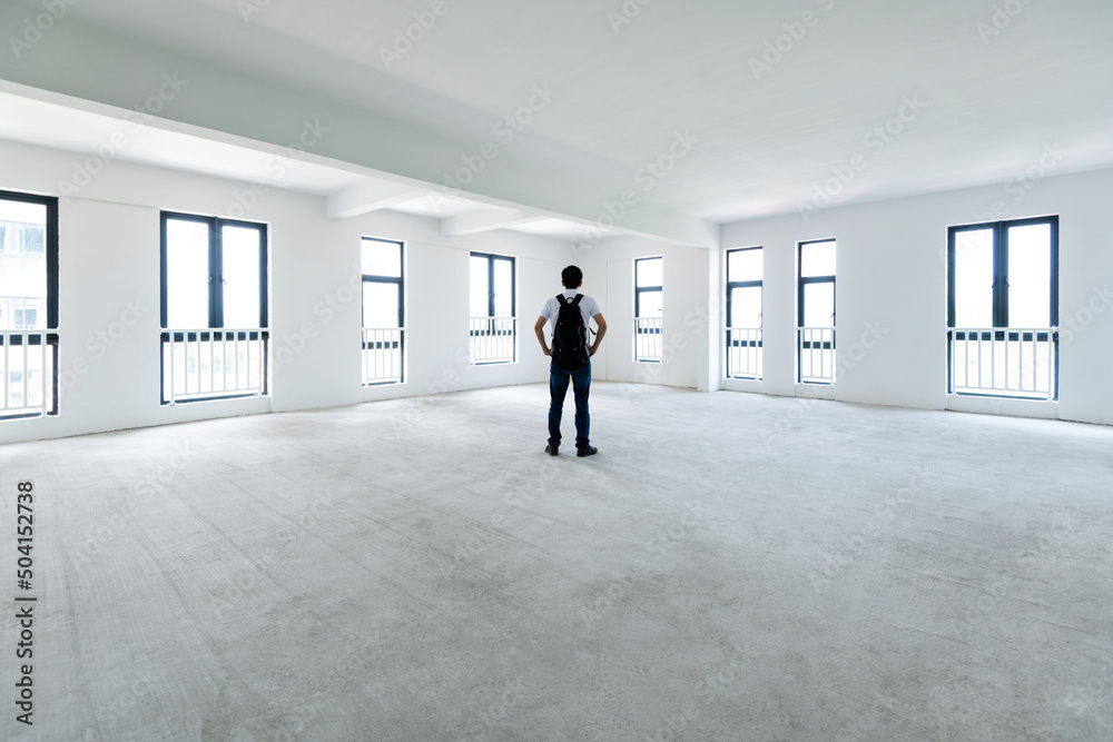 A man standing in empty office A man standing in empty office
