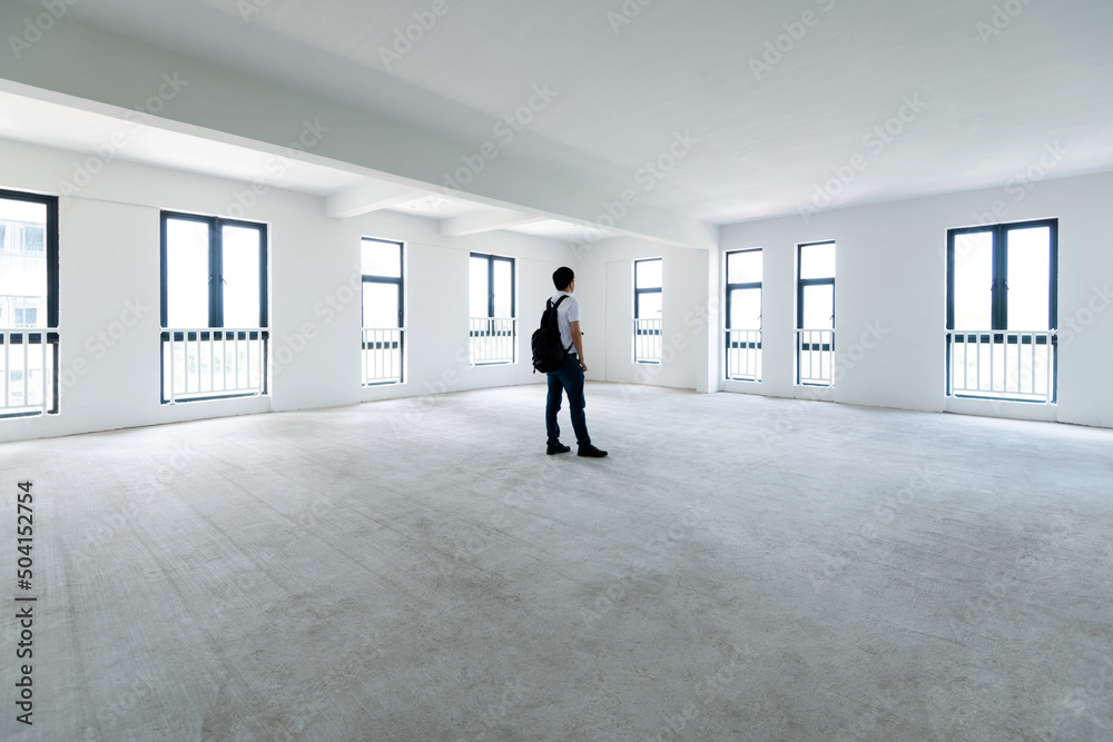 A man standing in empty office