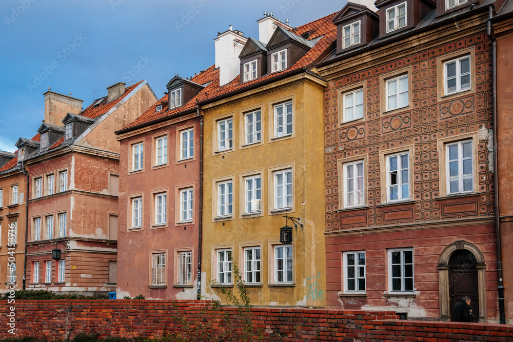 Warsaw, Poland, 13 October 2021: picturesque street with colorful buildings in historic center in medieval city, renaissance and baroque historical buildings near Barbican fortifications, sunny day