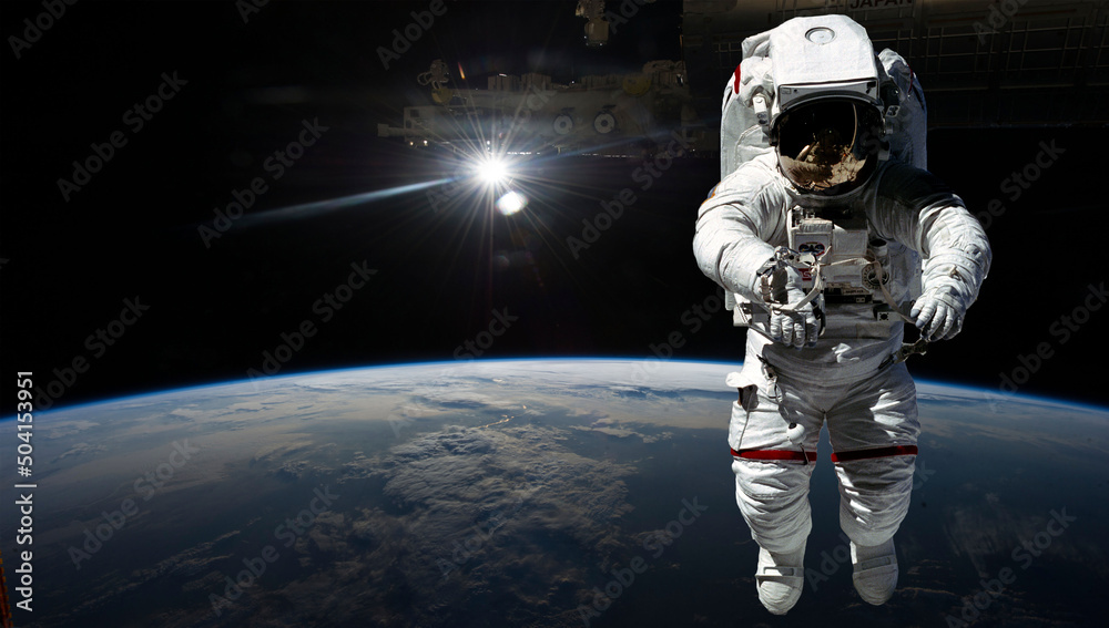 Naklejka premium Astronaut in outer space over the planet Earth. Our home. ISS. Elements of this image furnished by NASA.