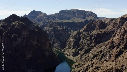 Aerial view of a boat on a canyon river in Kingman, USA - reverse, tilt, drone shot photo